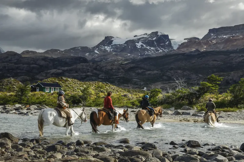 Crossing a river on horseback at Estancia Cristina